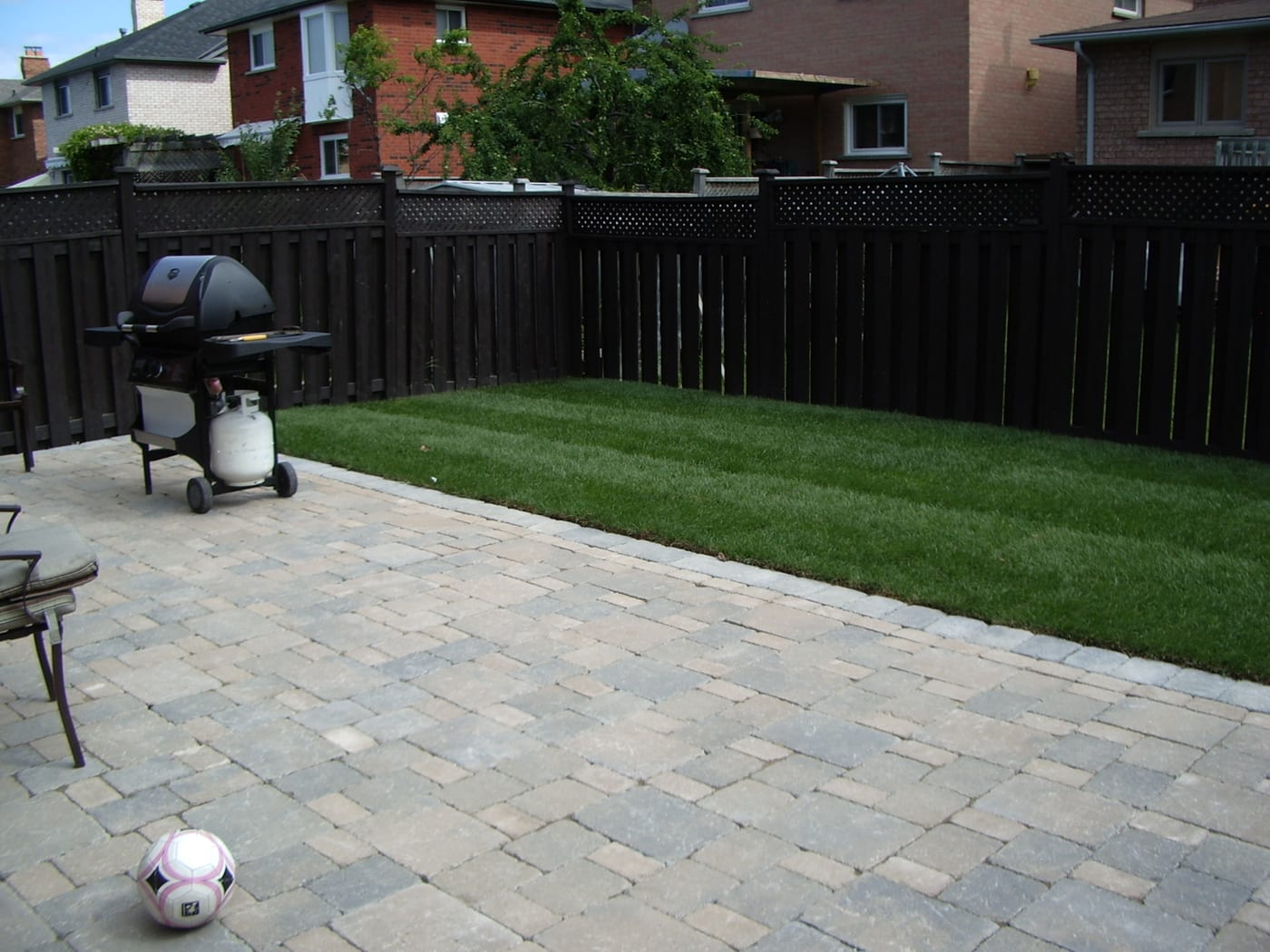 Rear patio in multi-tone stone with fresh lawn strip