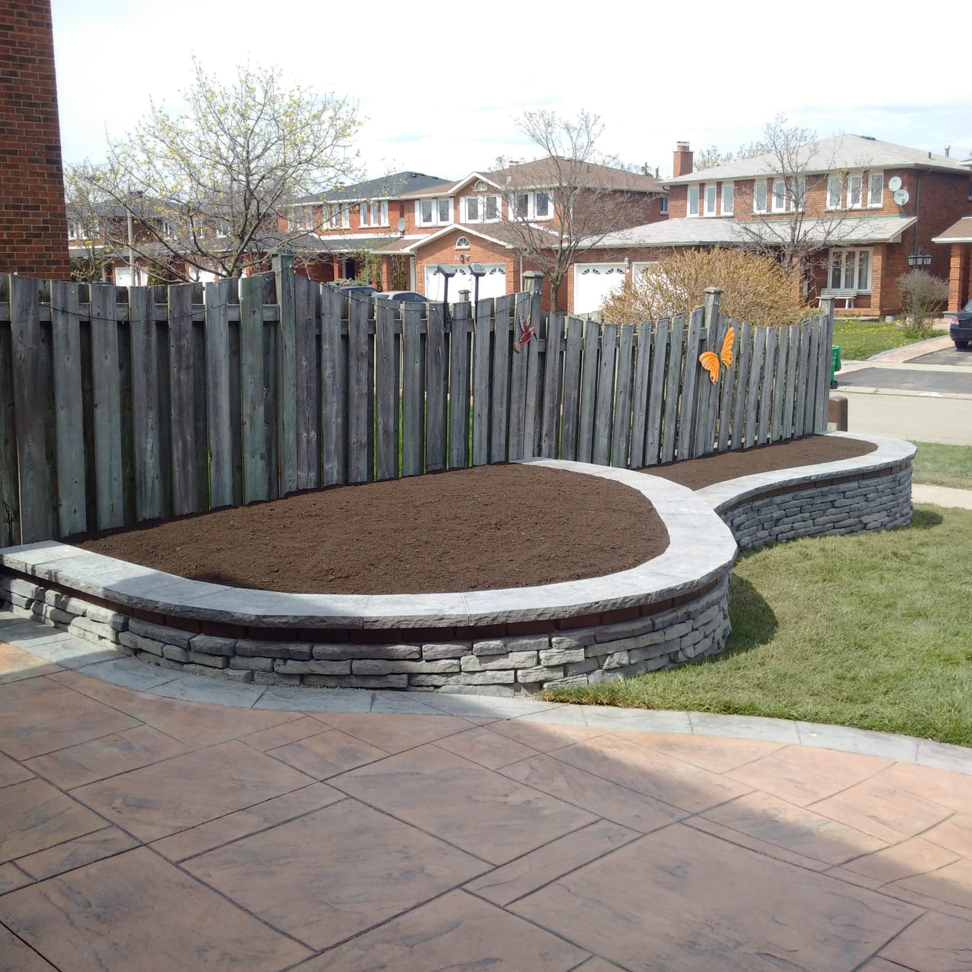Curved stone retaining wall at a Brampton residence