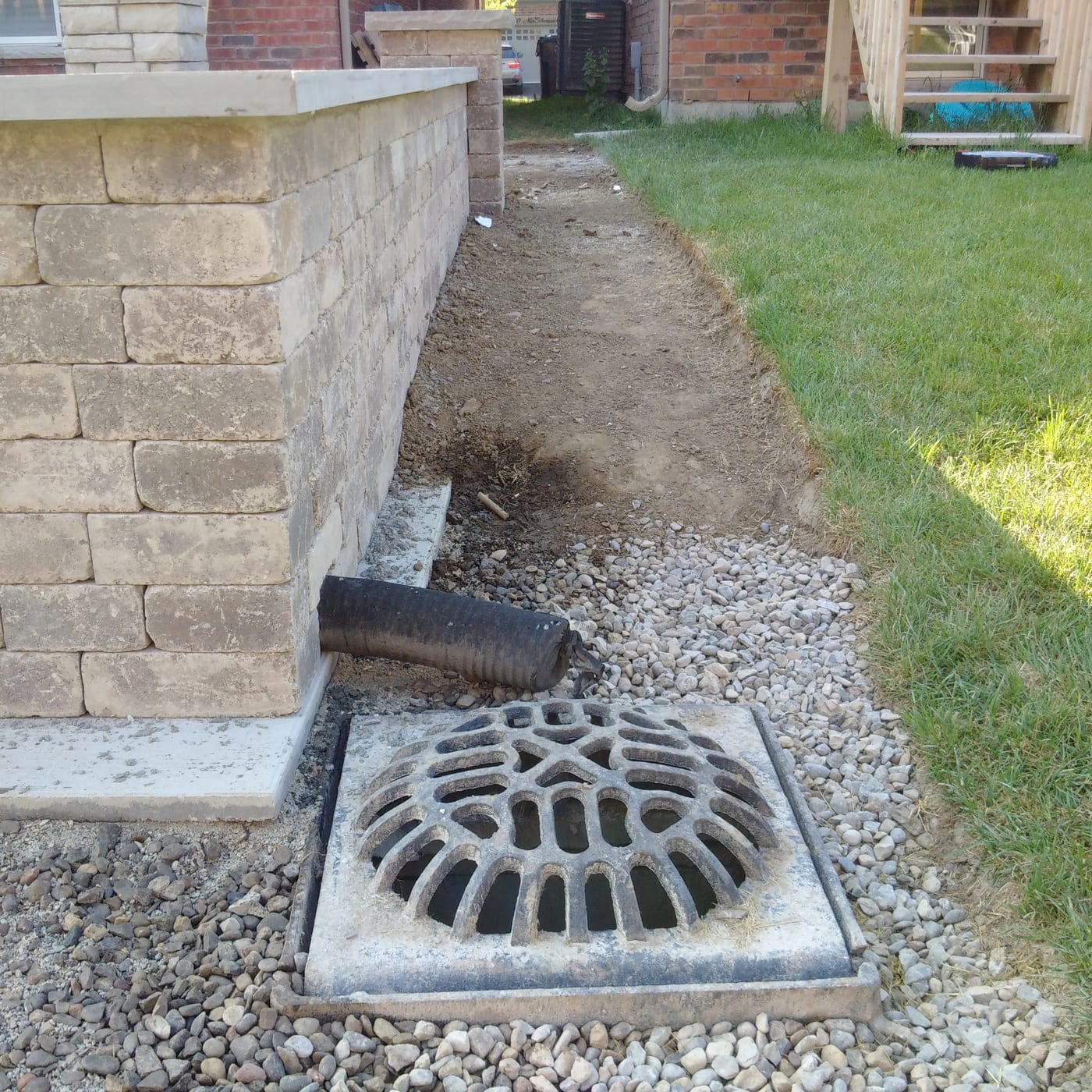 Drainage tie-in and excavated path during landscape groundworks